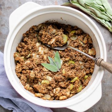 Casserole dish of vegan stuffing with sage on top.