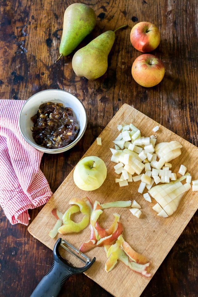 Diced apple and pear on a wooden board.