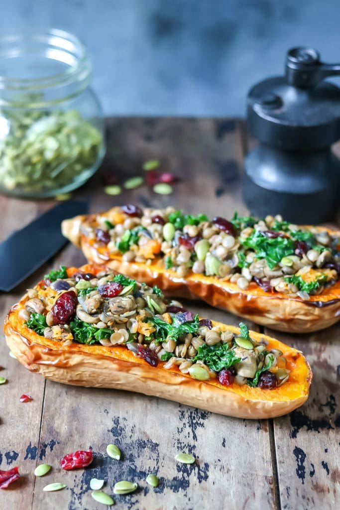 Table with lentil kale stuffed butternut squashes.