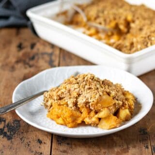 Close up of a plate of apple pumpkin crumble.