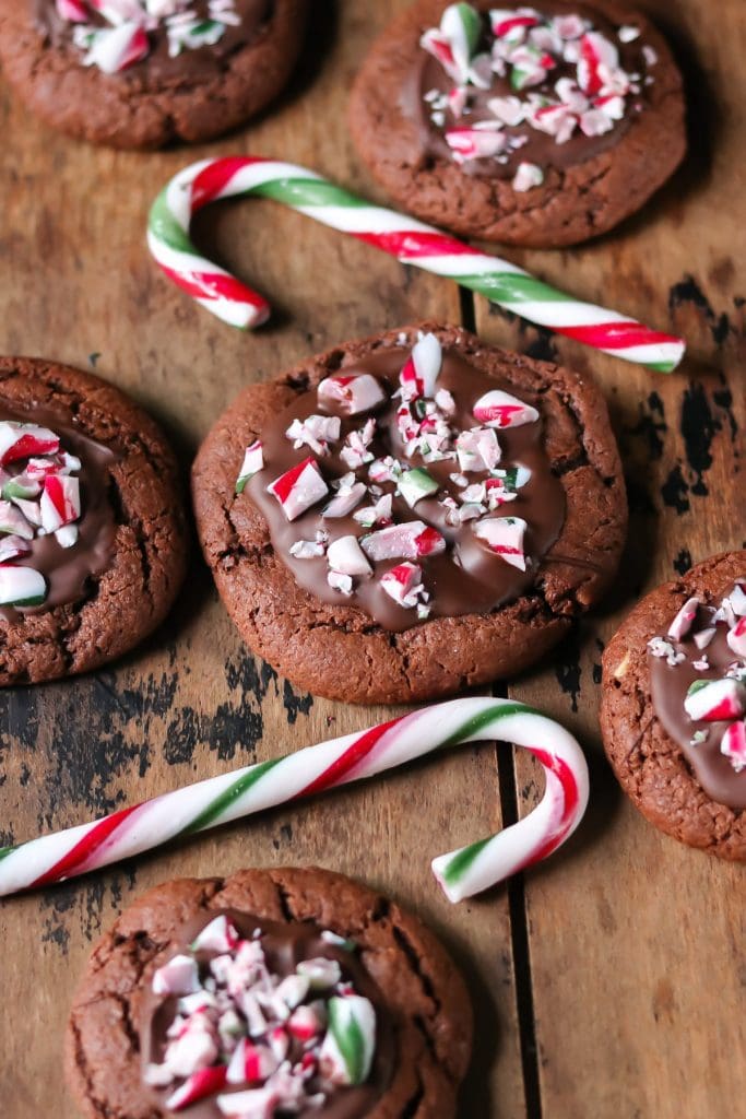 Chocolate peppermint biscuits next to candy canes.