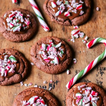 Chocolate cookies topped with melted chocolate and crushed candy canes.