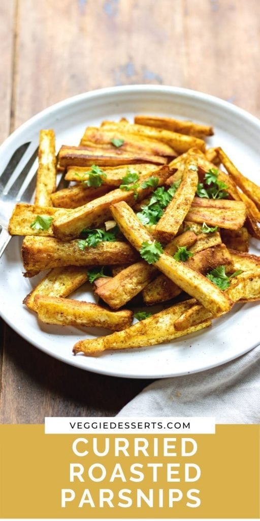 Close up of parsnips on a plate with text Curried Roasted Parsnips.