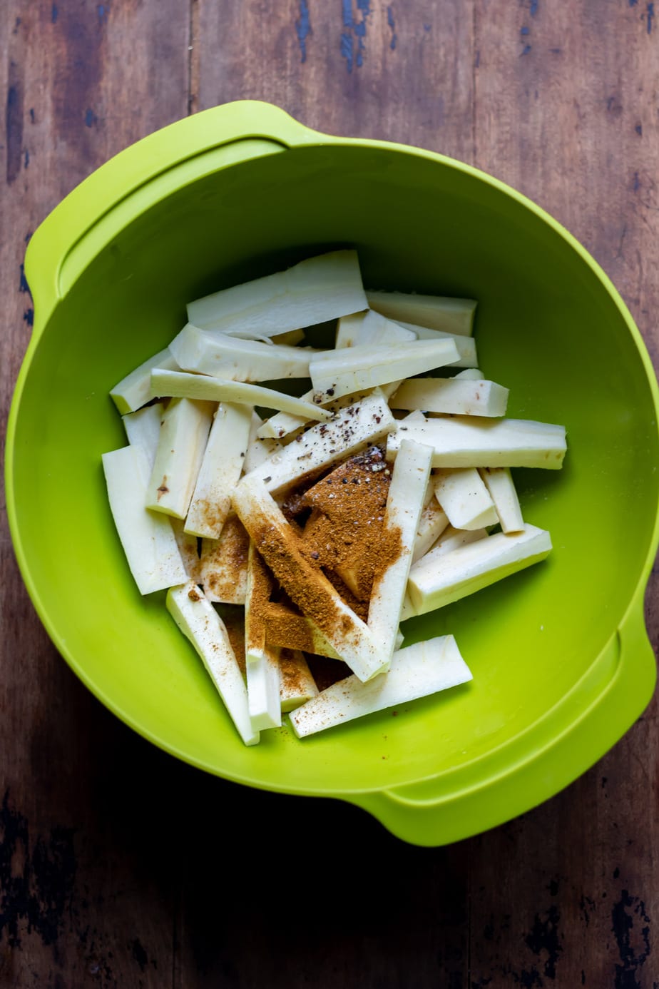 Bowl of parsnip strips and spices.