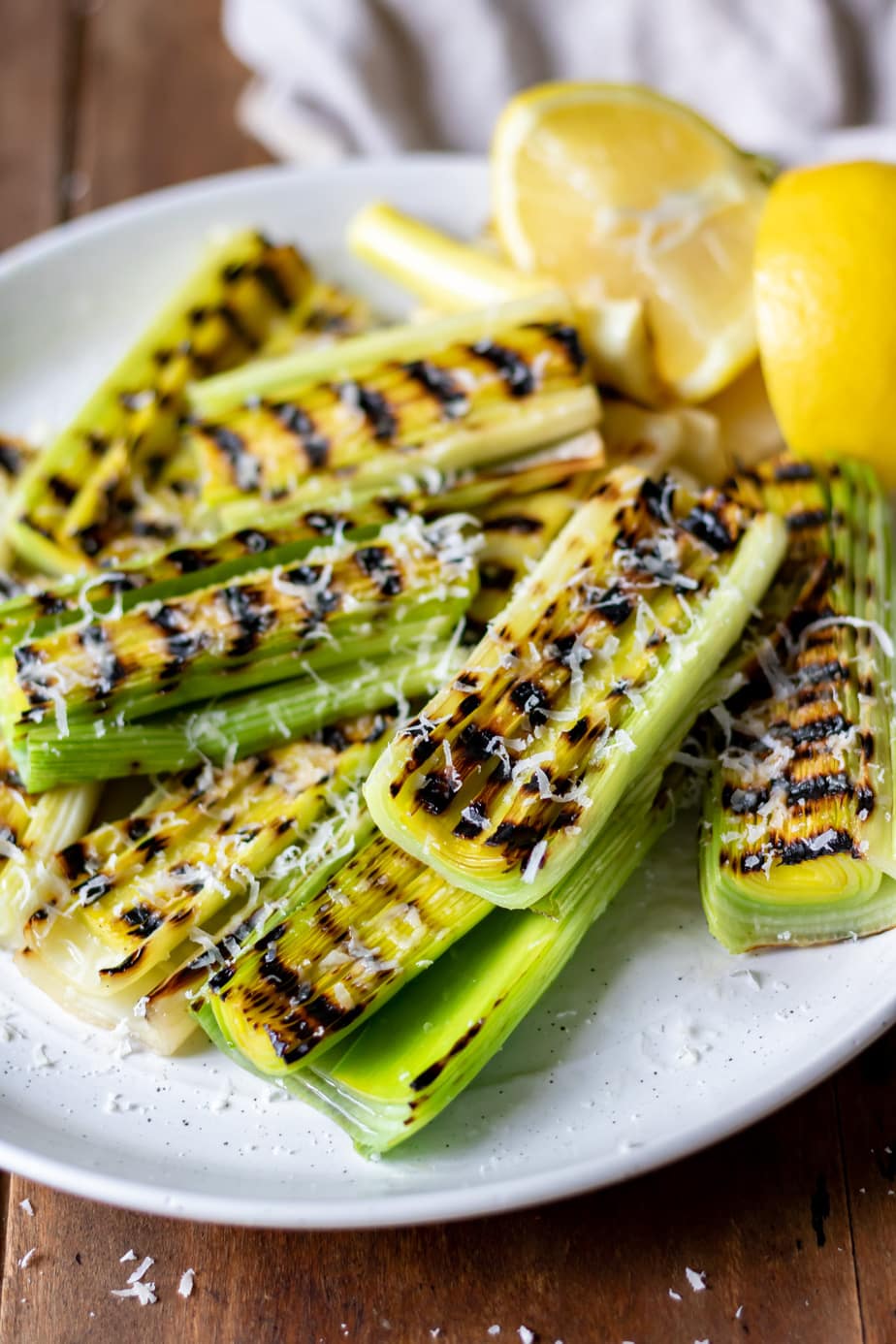 Close up of grilled leeks on a plate.