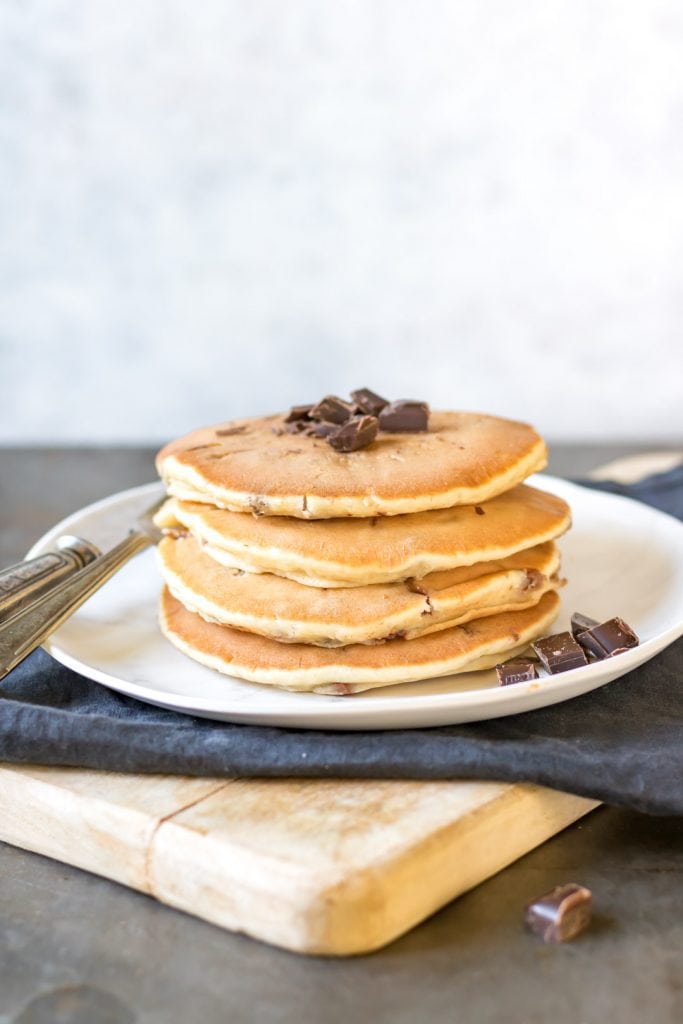 Stack of pancakes with chocolate chips on top.