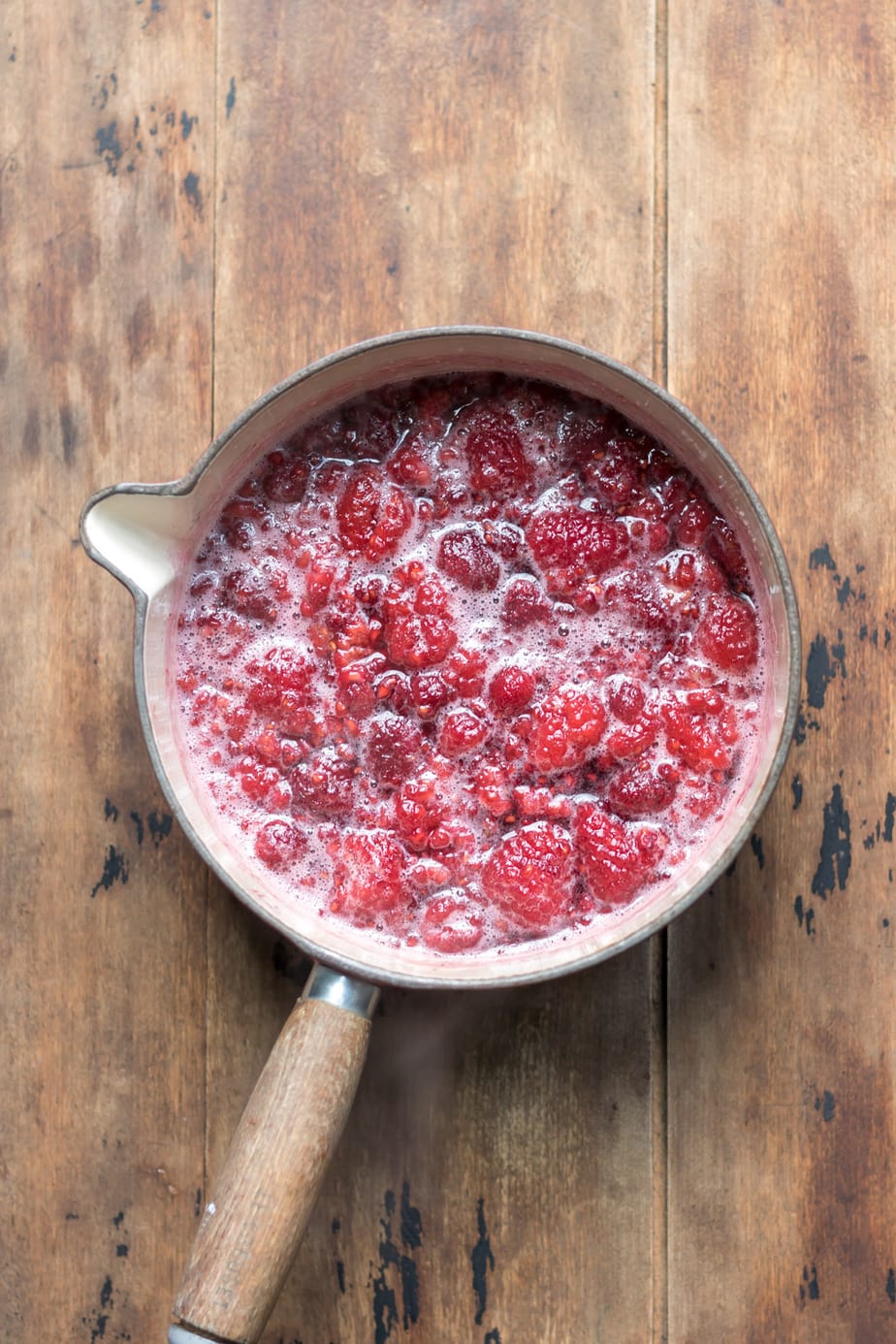 Cooked raspberries in sugar water.