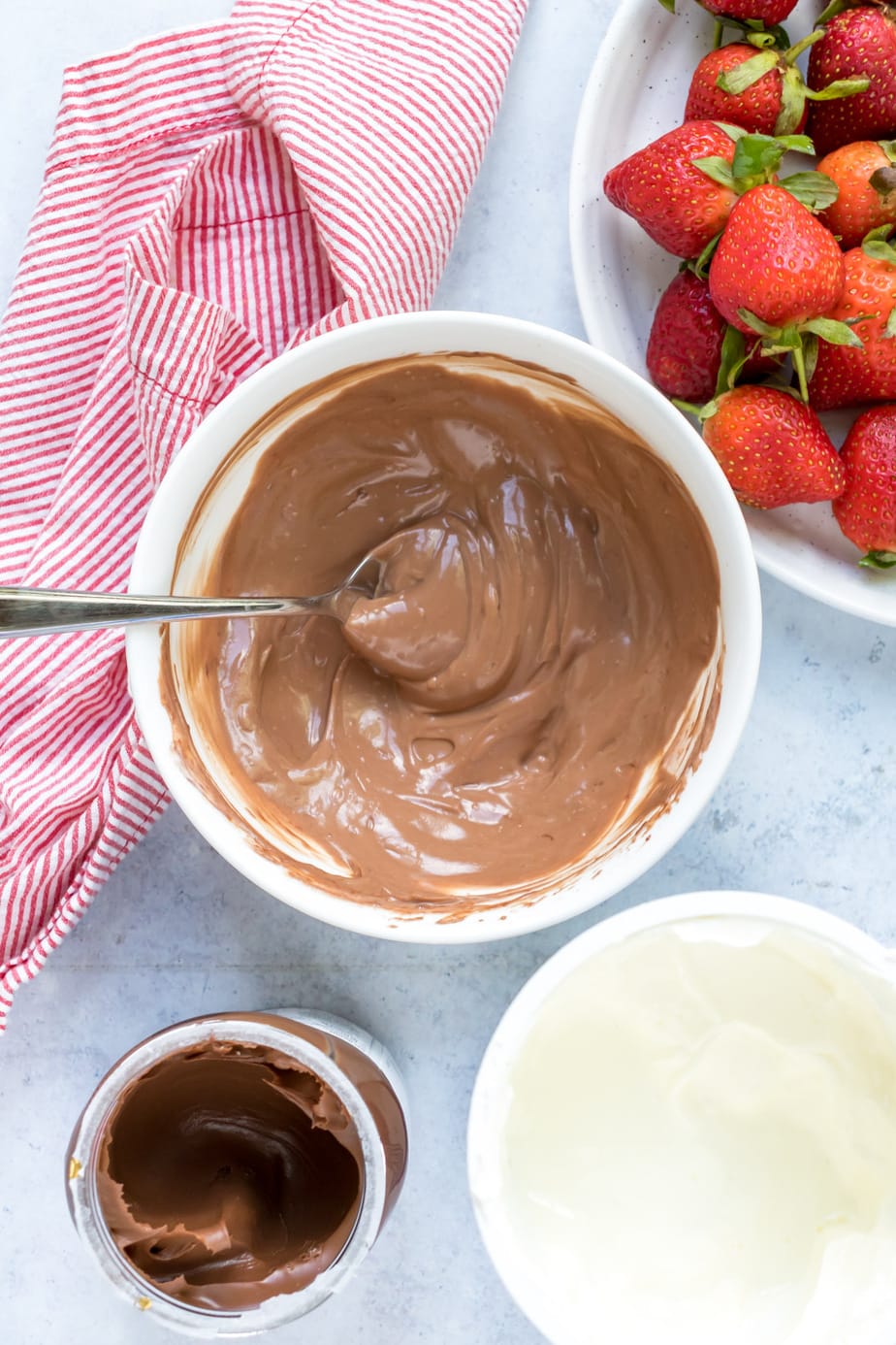 Mixing nutella and yogurt in a bowl.
