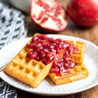 Waffles with pomegranate compote on them.