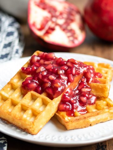 Waffles with pomegranate compote on them.