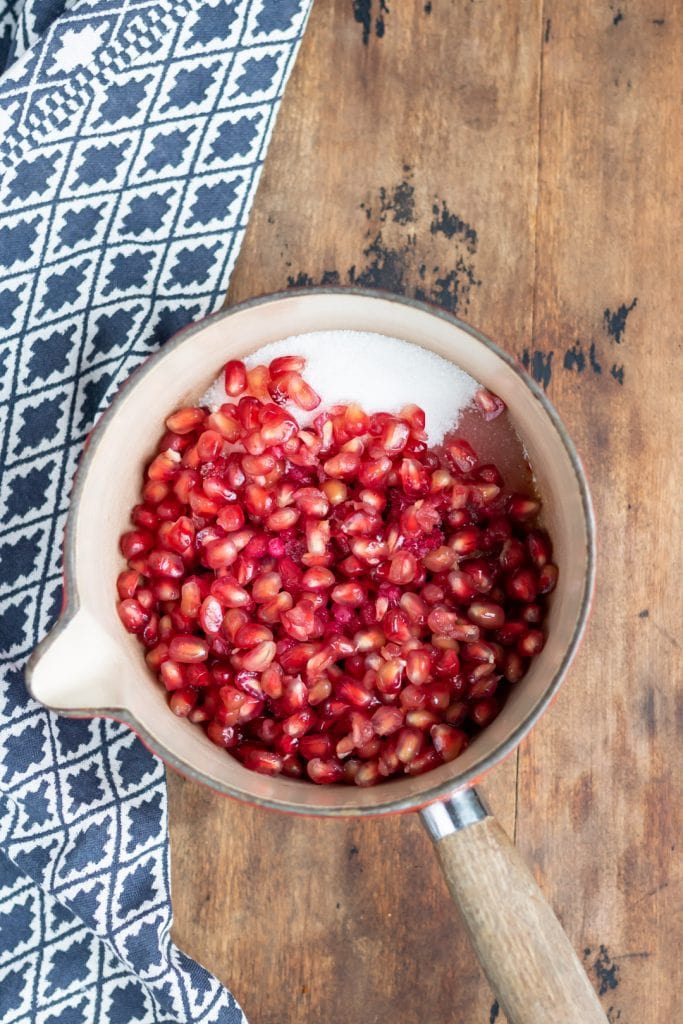 Ingredients for pomegranate compote in pot.