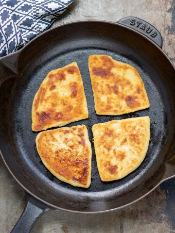 Skillet with potato farls in it.
