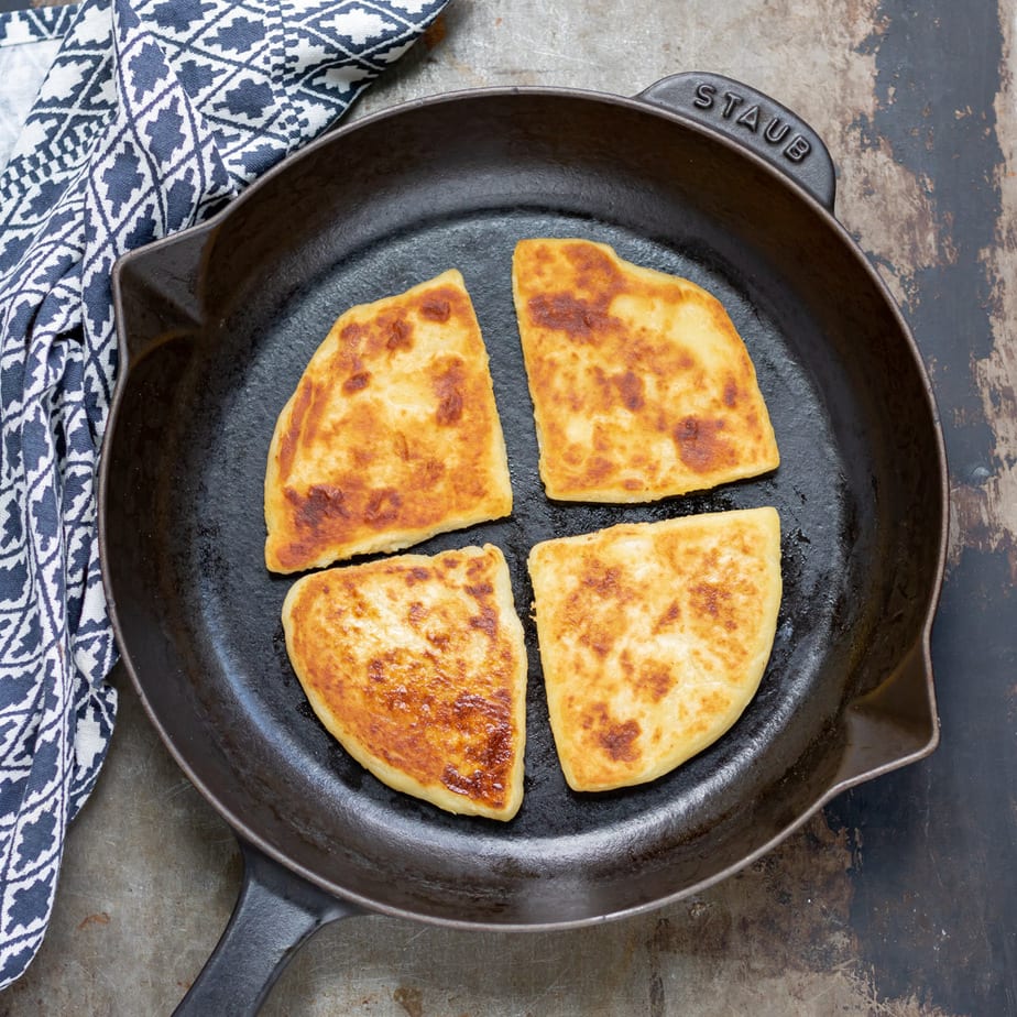 Skillet with potato farls in it.