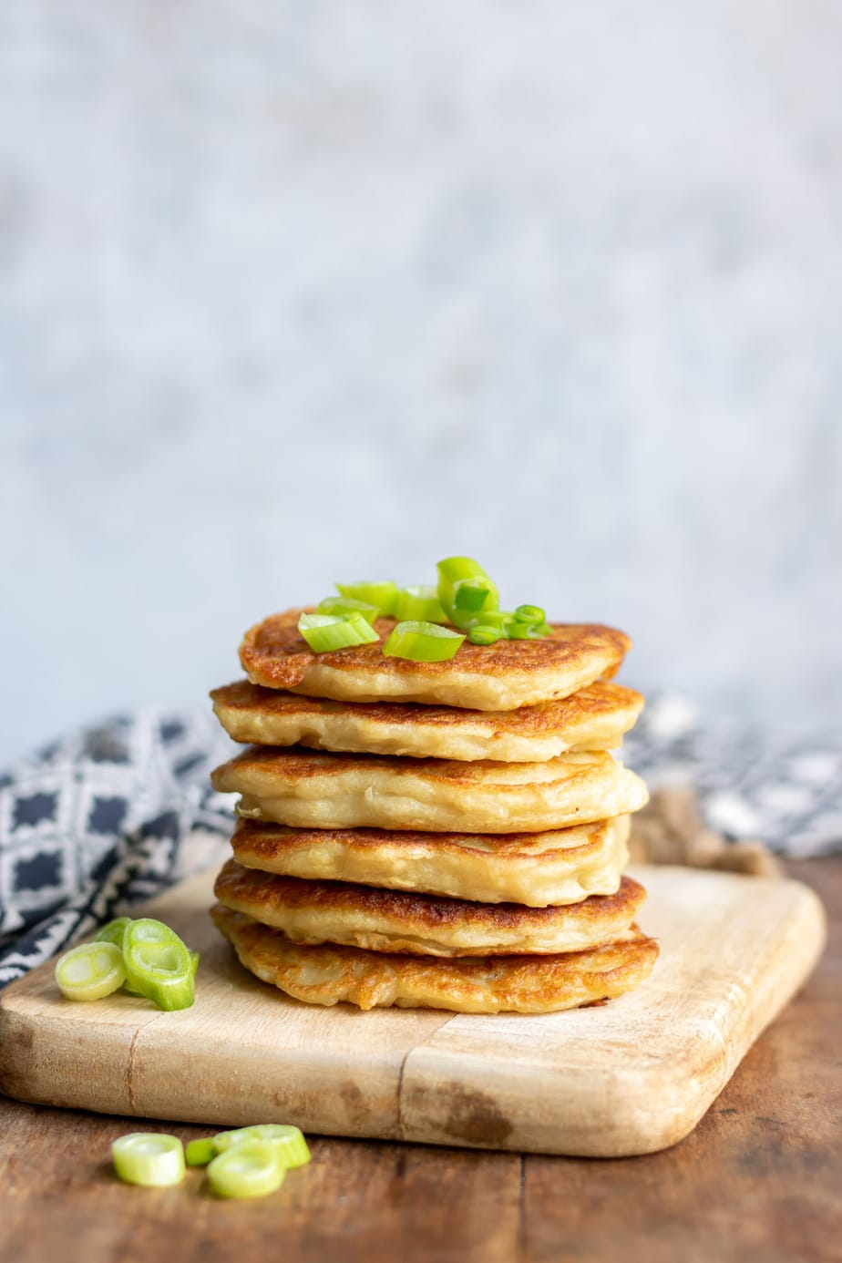 Stack of boxty with scallions on top.