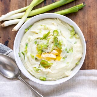 Bowl of mash with spring onions.