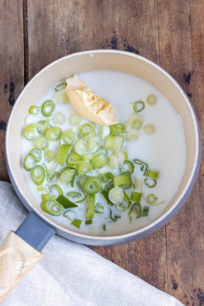 Pot with milk, butter and scallions.
