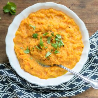 Spoon in a serving dish of carrot swede mash.