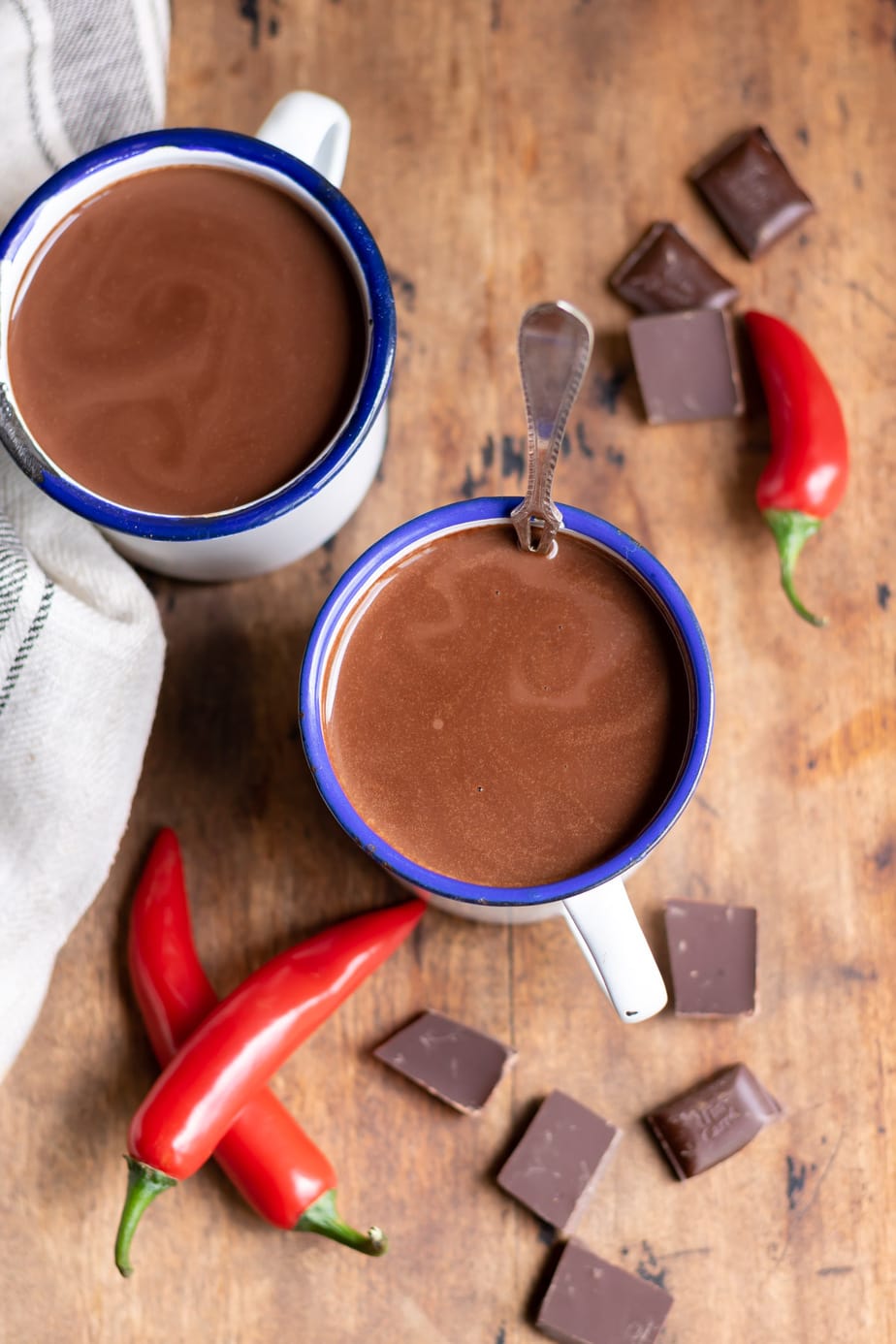 Looking down at two mugs of hot chocolate.