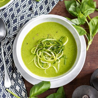 Bowl of soup with spiralized zucchini on top.