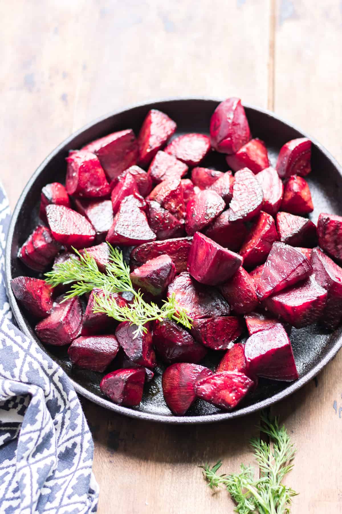 Dish of beets, with a sprig of dill.