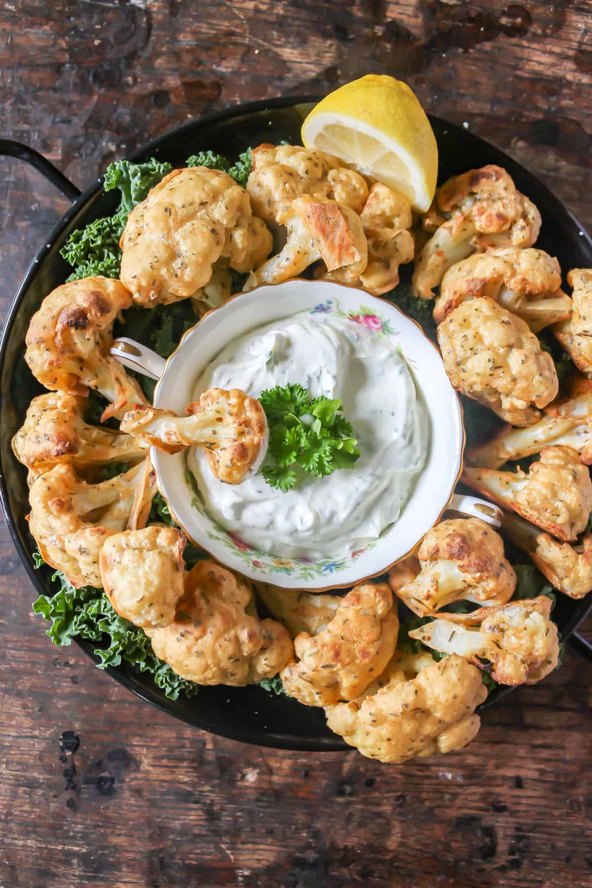 Serving tray of cauliflower wings with dip.
