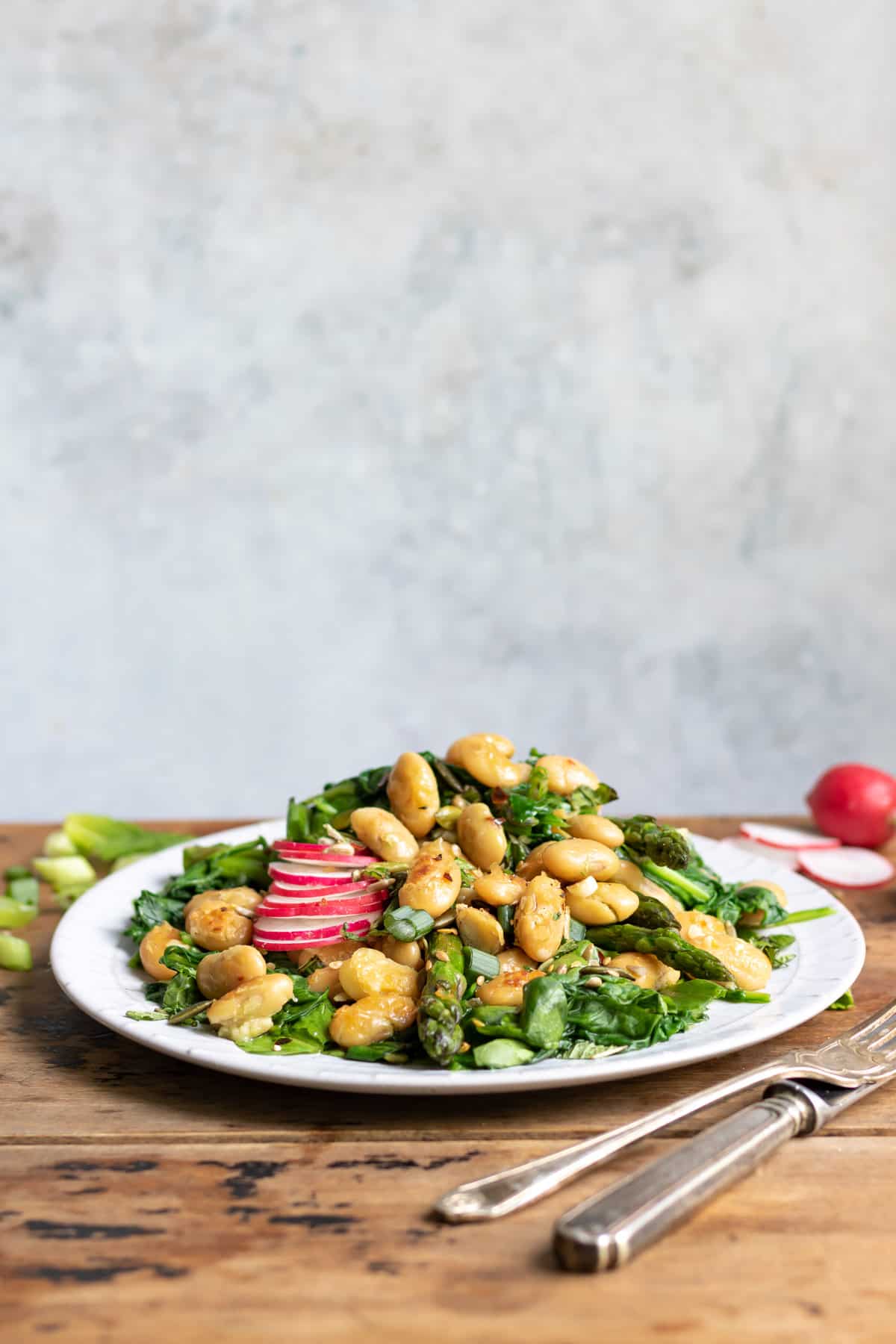 Plate of salad on a table.