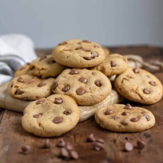 Pile of cookies on a wooden table.