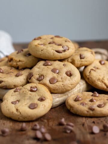 Pile of cookies on a wooden table.