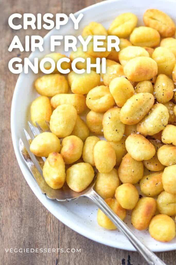 Close up of gnocchi on a plate with text: Crispy Air Fryer Gnocchi.