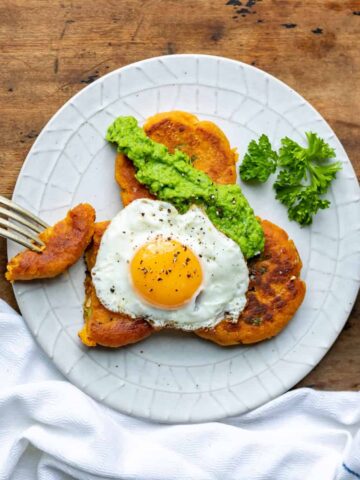 Plate with sweet potato patties topped with a fried egg.