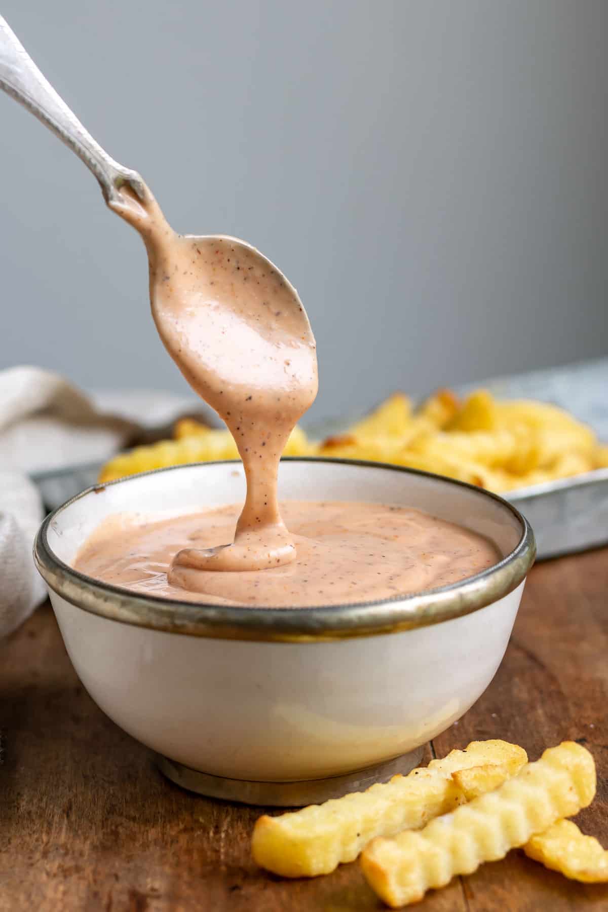 Spoon coming out of a bowl of zax sauce.