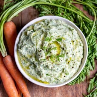 Close up of a bowl of carrot top dip.