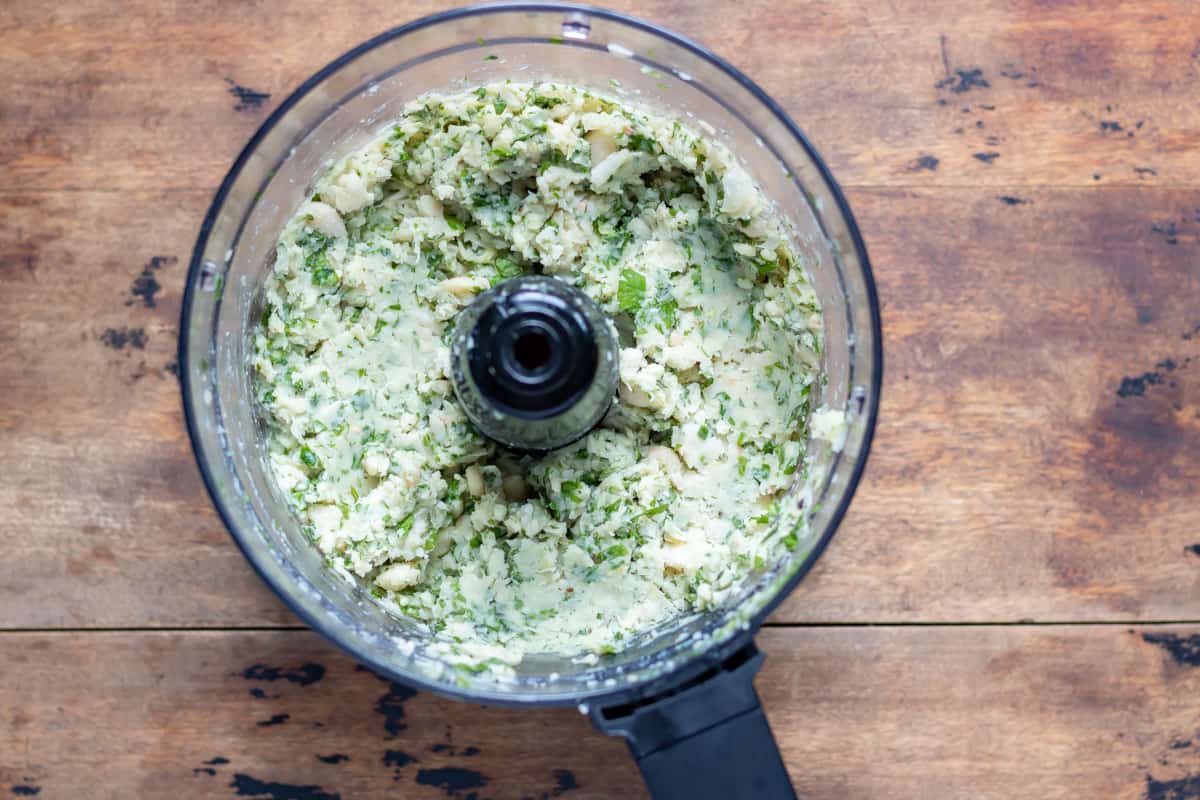 Food processor with whizzed ingredients.