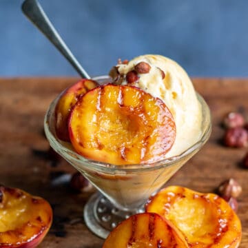 Bowls of ice cream with cooked nectarines.