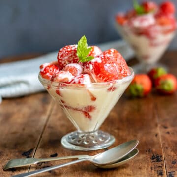 Glass of cream and strawberries.