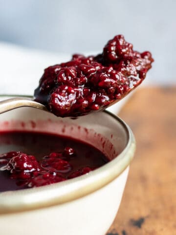 Spoonful of blackberry compote on a bowl.