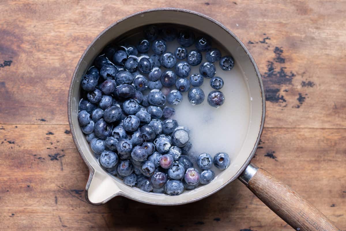 Pot of blueberries, sugar and water.