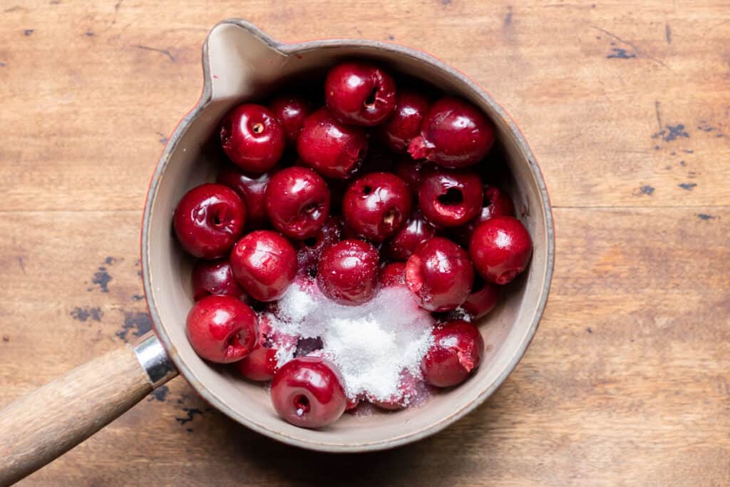Pan with cherries and sugar.