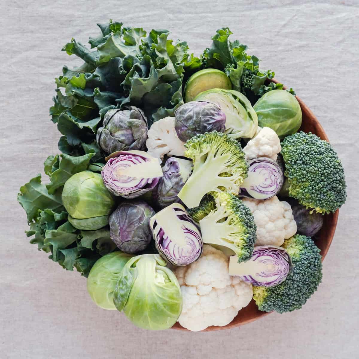 A bowl of kale, broccoli, brussels sprouts and cauliflower.