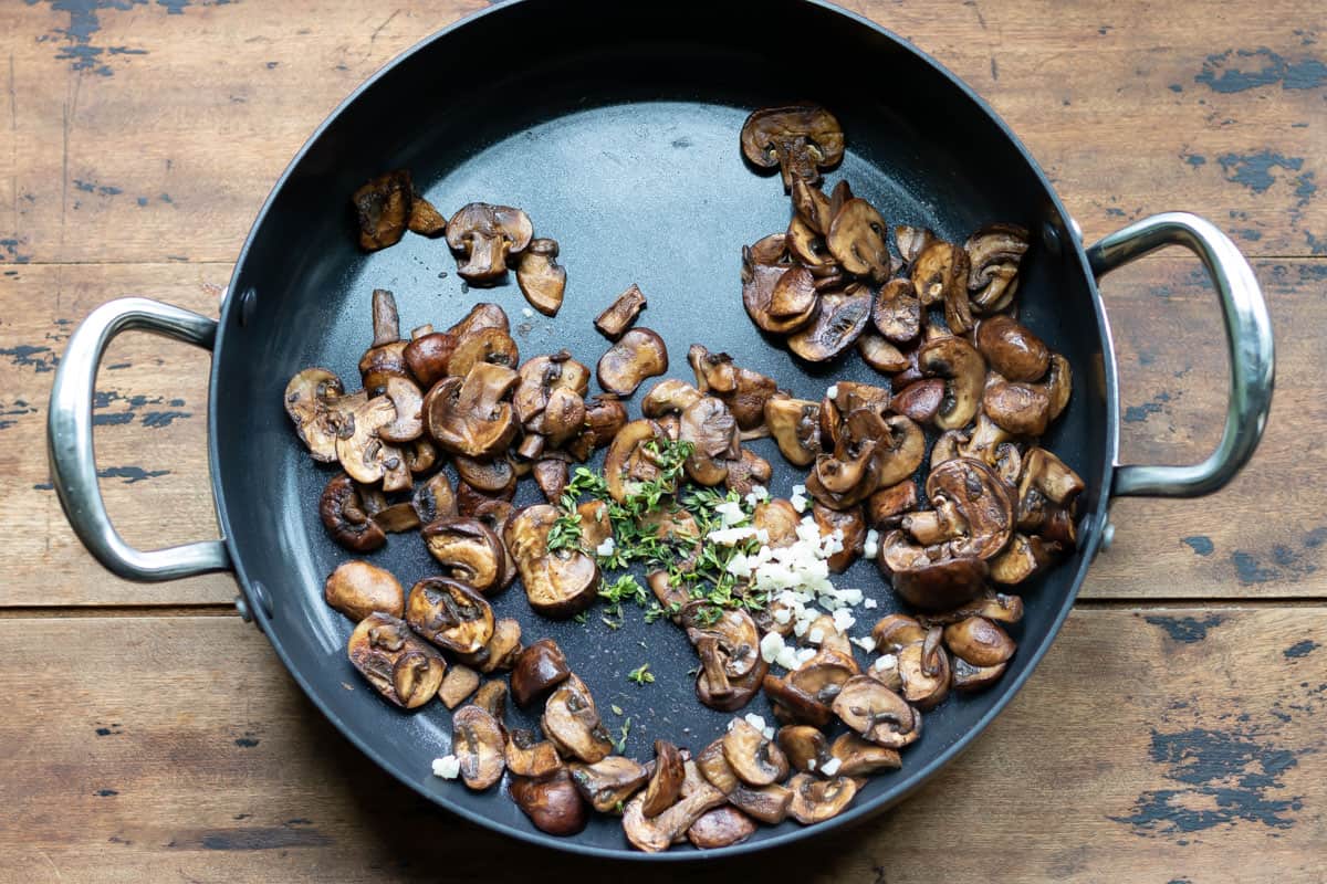 Sauteed mushrooms in a pan.