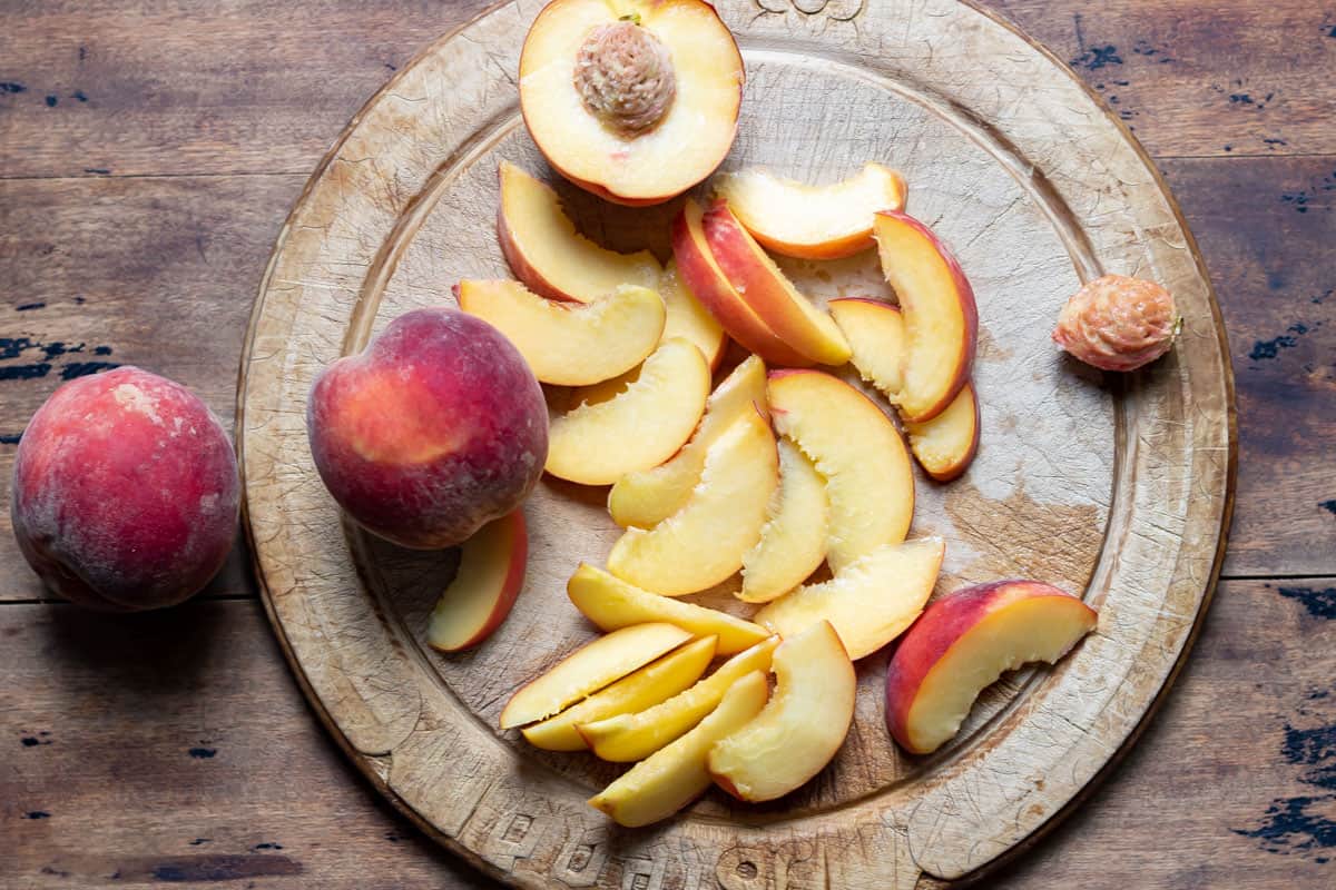 Sliced peaches on a cutting board.
