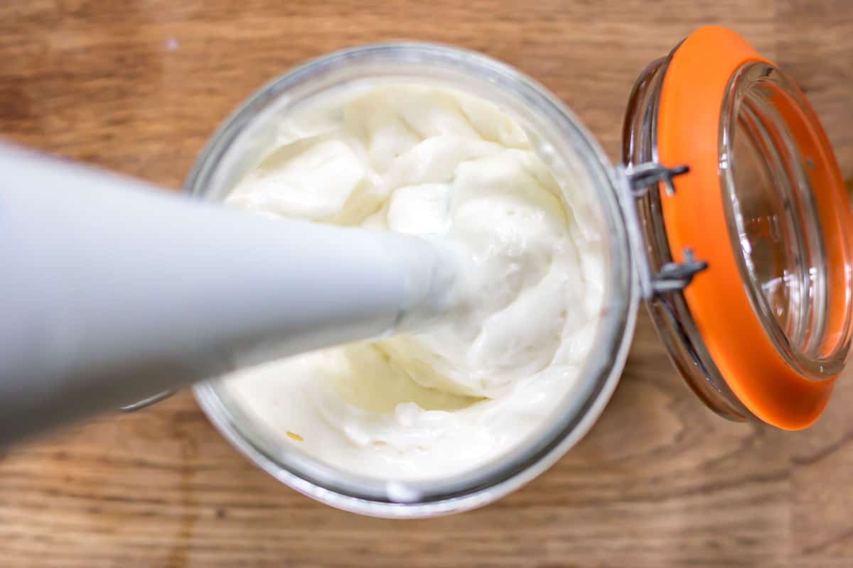 Hand blender in a jar of mayo.