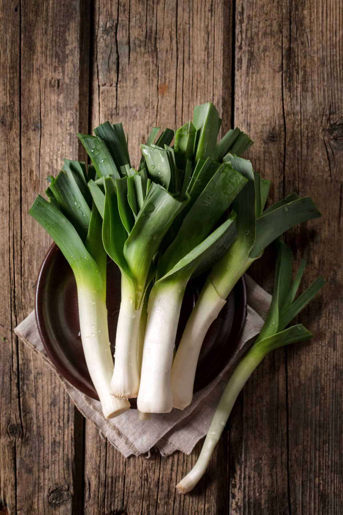 Leeks on a wooden table.