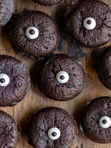 Rows of mini halloween brownie bites topped with candy eyes.
