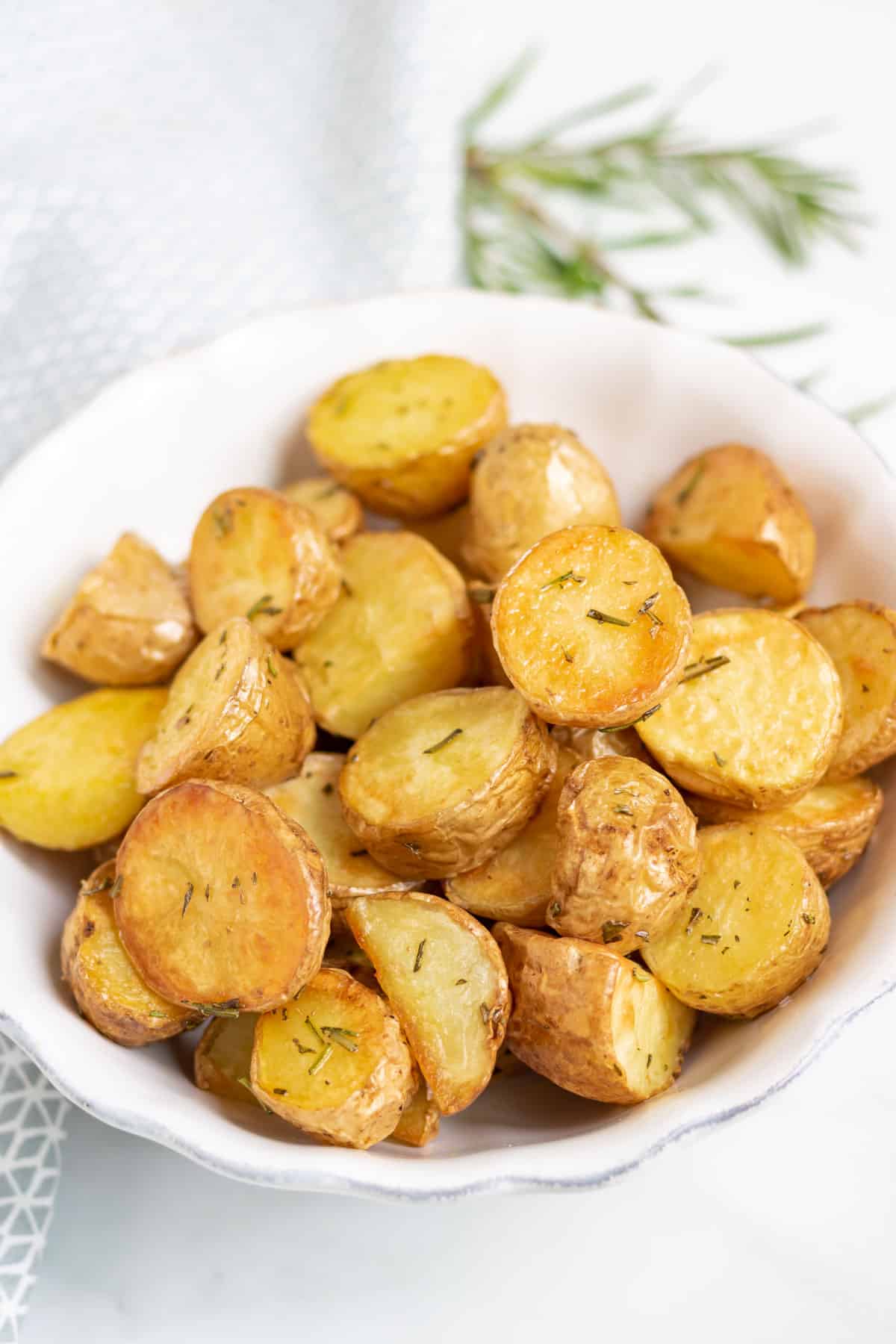 A serving dish of roasted baby potatoes.