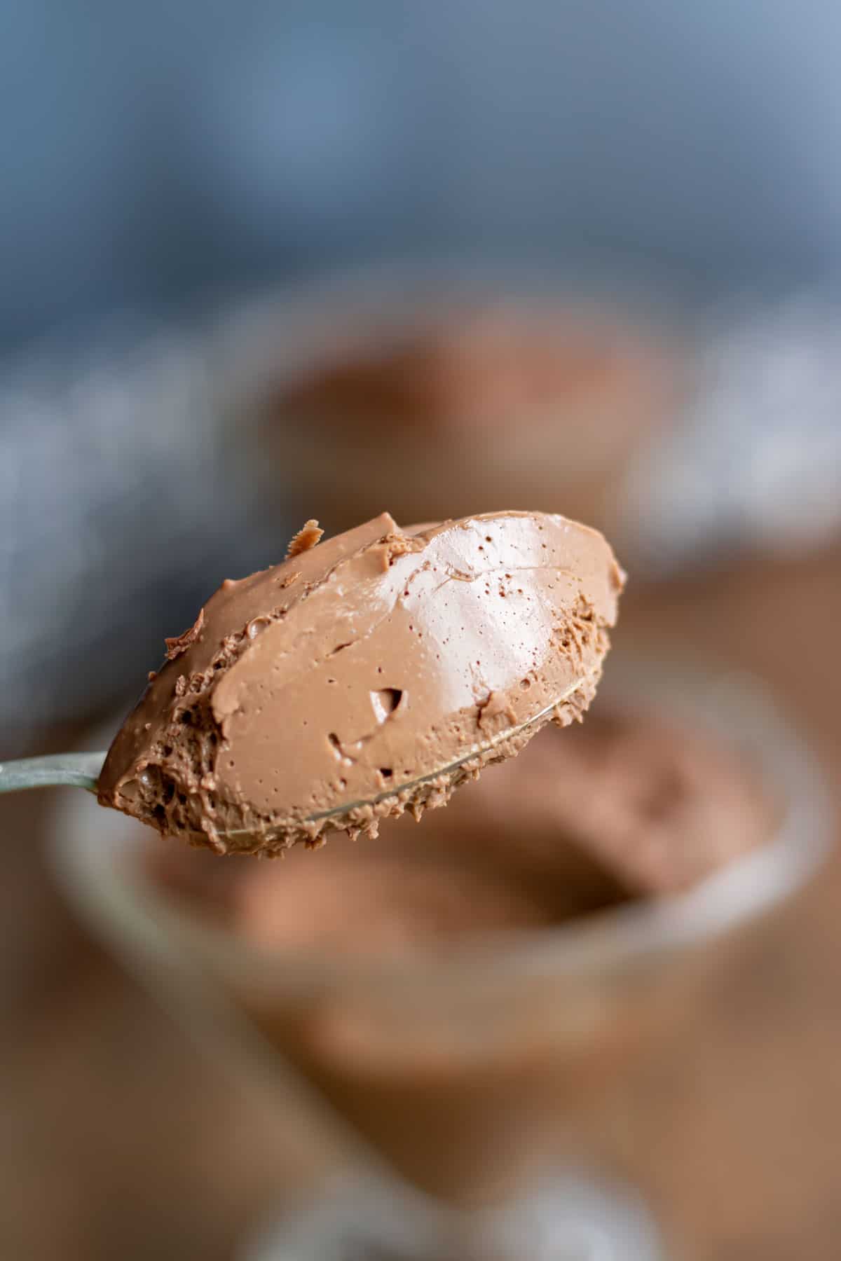 Close up of a spoonful of smooth chocolate mousse.