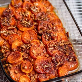 Close up of a sweet potato casserole in a glass baking dish.