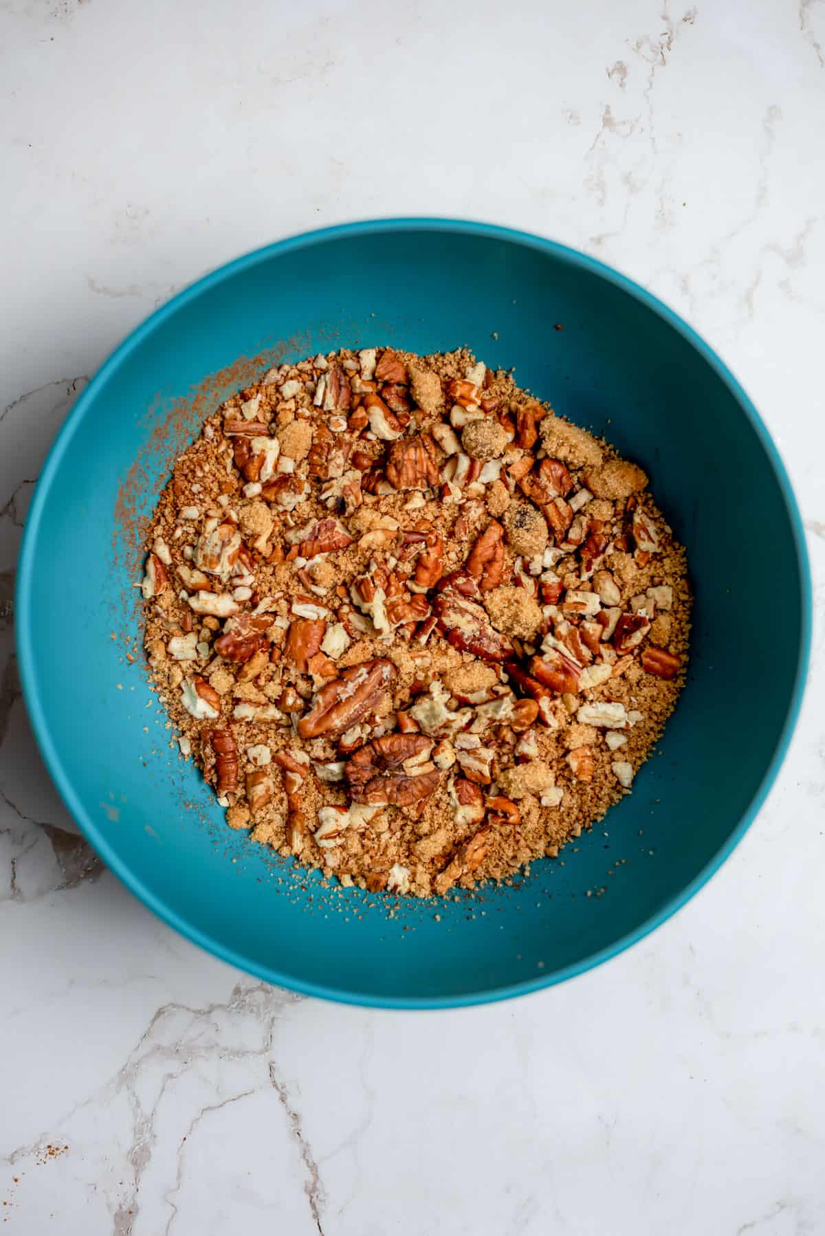 A bowl of pecan crunch topping.