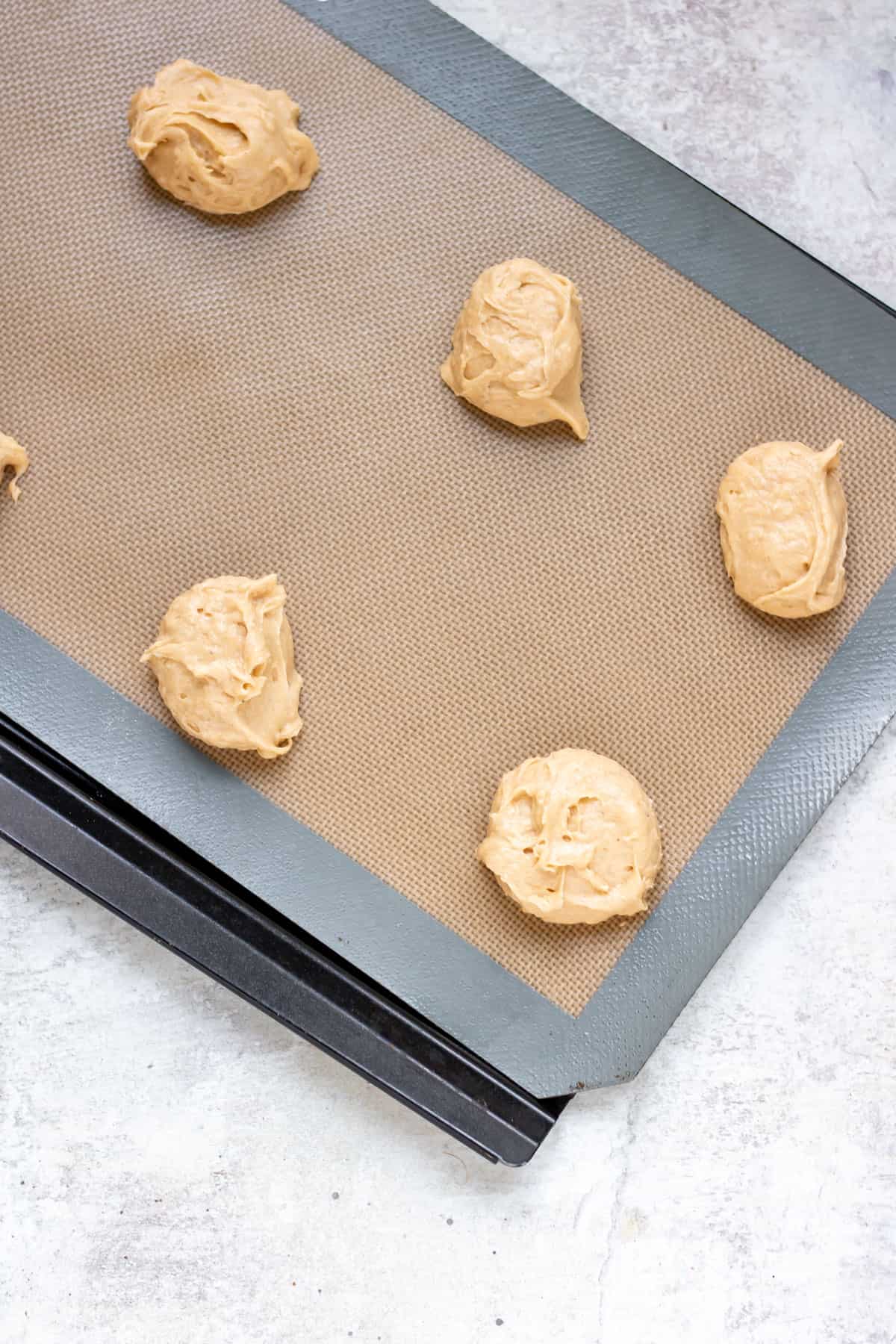 Cookie dough on baking sheet.