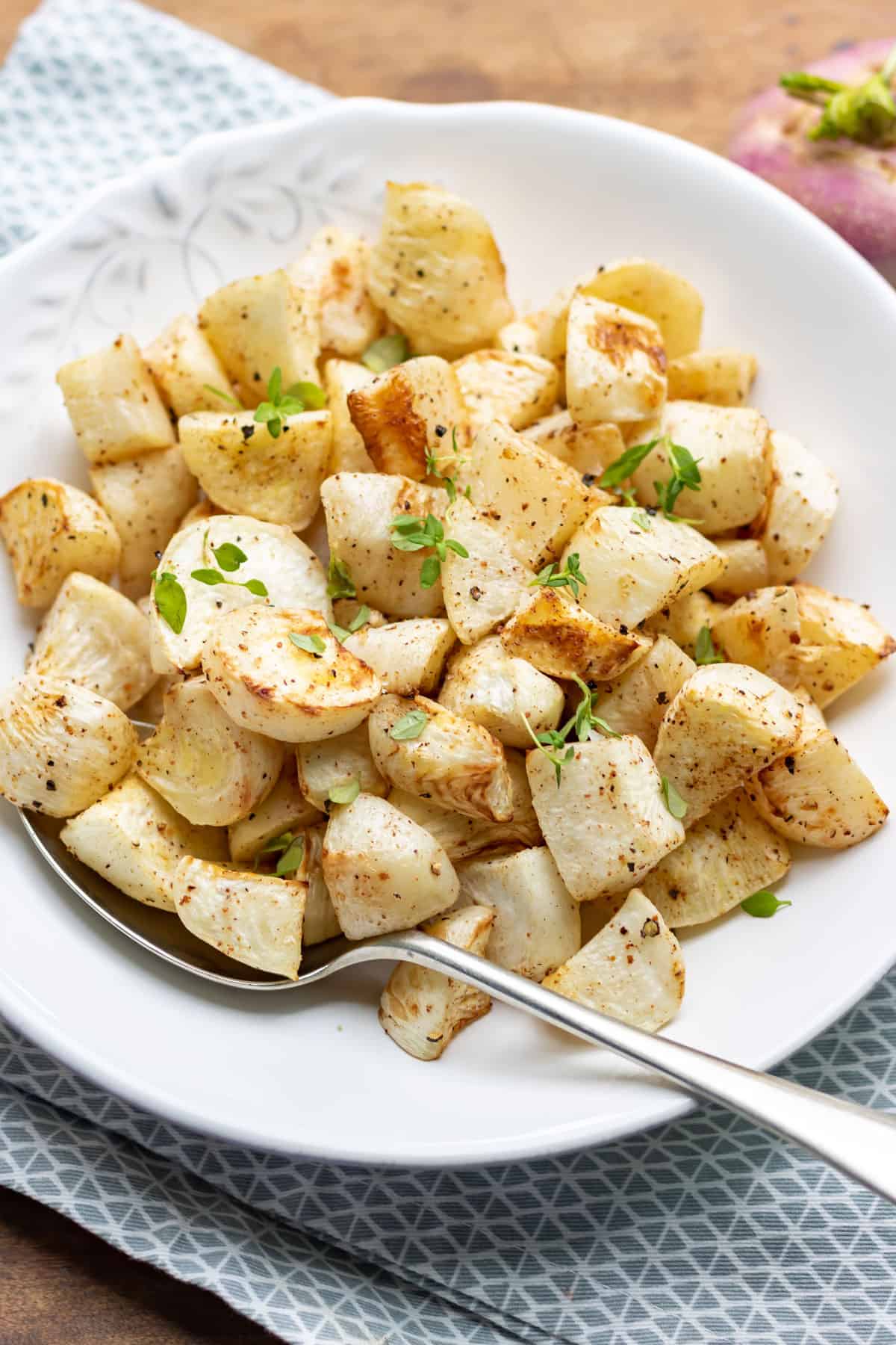 A plate of roasted turnip on a table.